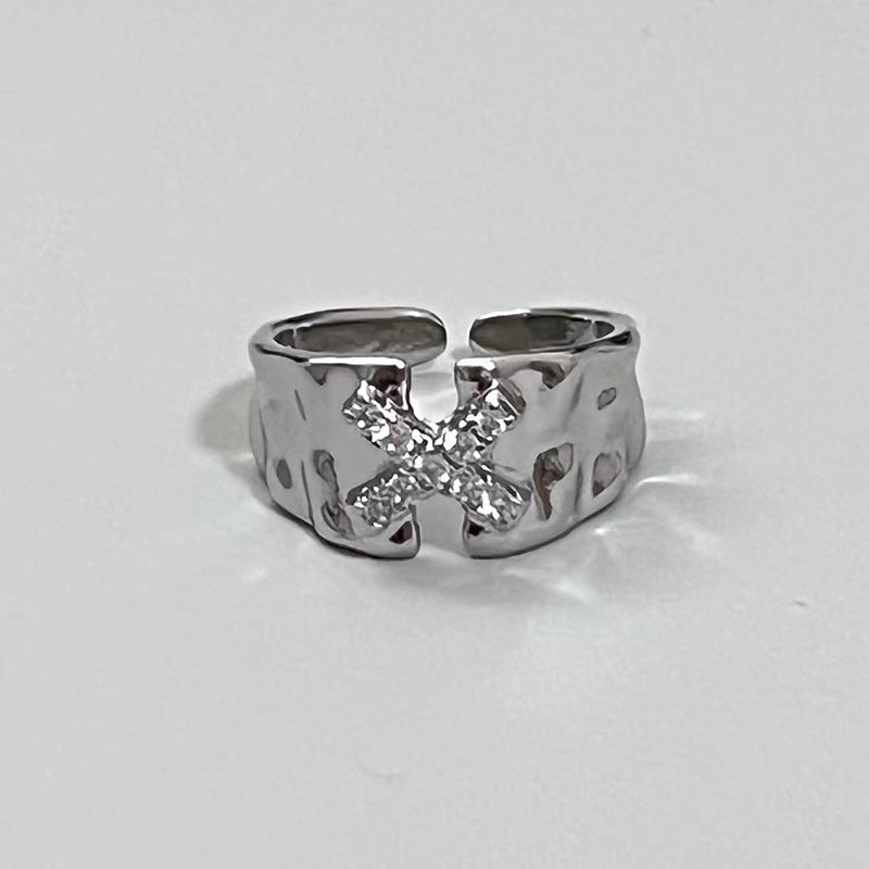 Ring with the letter X zircon